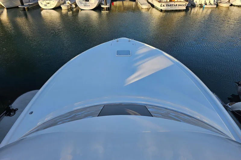 Slide: The Image of 2013 Viking 42 Convertible yacht docked at marina, viewed from above. - 14