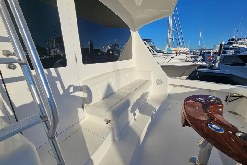Slide: The Image of 2013 Viking 42 Convertible yacht interior with seating and polished wood details. - 16