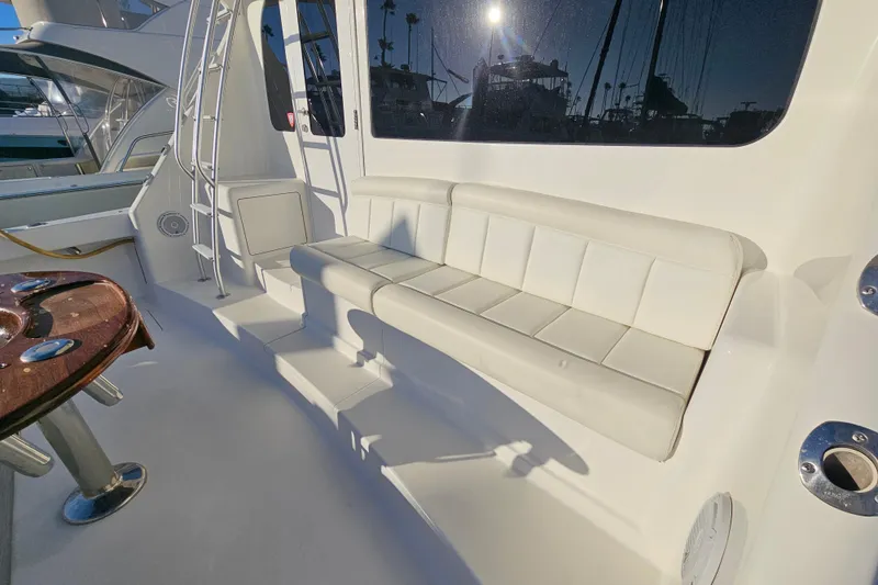 Slide: The Image of 2013 Viking 42 Convertible yacht with white seating and polished wood table. - 17