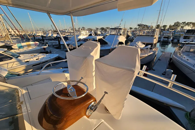 Slide: The Image of 2013 Viking 42 Convertible yacht docked in a marina at sunset. - 22