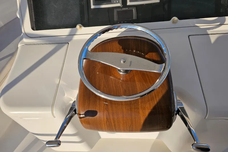 Slide: The Image of Steering wheel of 2013 Viking 42 Convertible yacht with wood and chrome finish. - 24