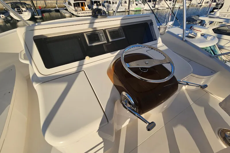 Slide: The Image of 2013 Viking 42 Convertible yacht helm with steering wheel and control panel. - 26