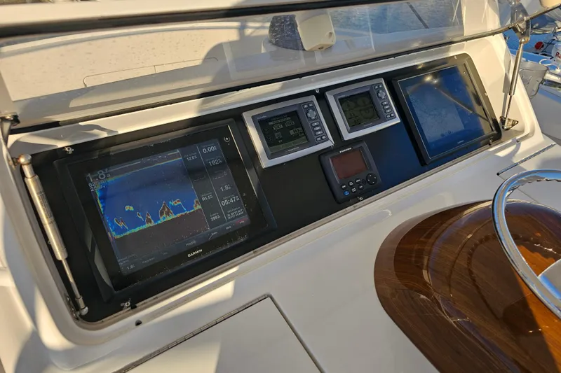 Slide: The Image of 2013 Viking 42 Convertible yacht dashboard with navigation and sonar displays. - 29