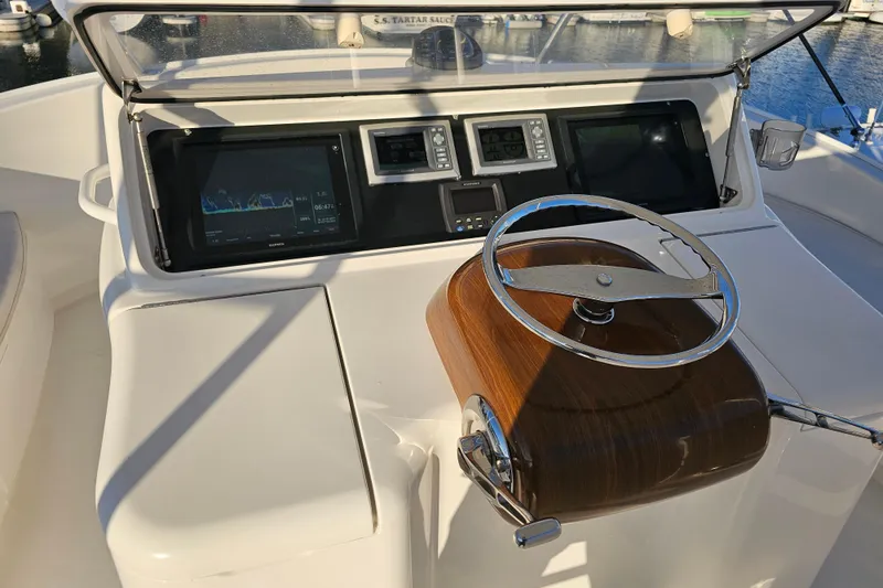 Slide: The Image of Steering console of a 2013 Viking 42 Convertible yacht with navigation displays. - 30