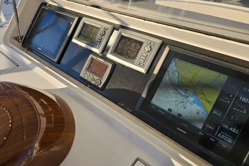 Slide: The Image of 2013 Viking 42 Convertible yacht dashboard with navigation and control displays. - 31