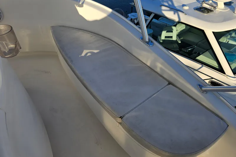 Slide: The Image of 2013 Viking 42 Convertible boat seating area with cushioned bench and railing. - 32