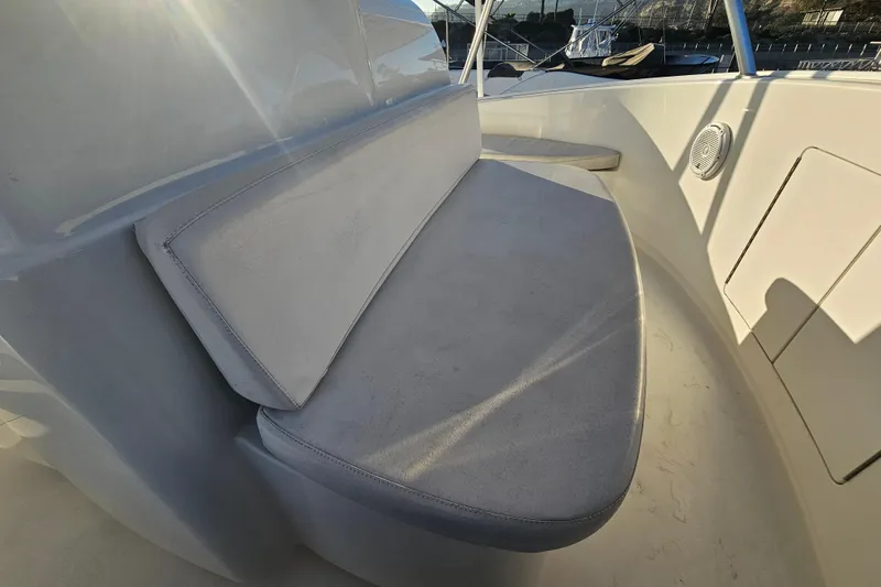 Slide: The Image of 2013 Viking 42 Convertible boat seating area with sunlight and speaker detail. - 35