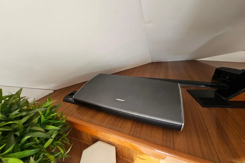 Slide: The Image of Bose sound system on 2013 Viking 42 Convertible yacht with wooden interior and plant decor. - 38