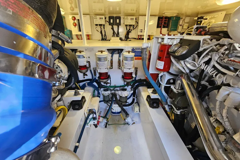 Slide: The Image of Engine room of 2013 Viking 42 Convertible yacht, showcasing complex machinery and components. - 40