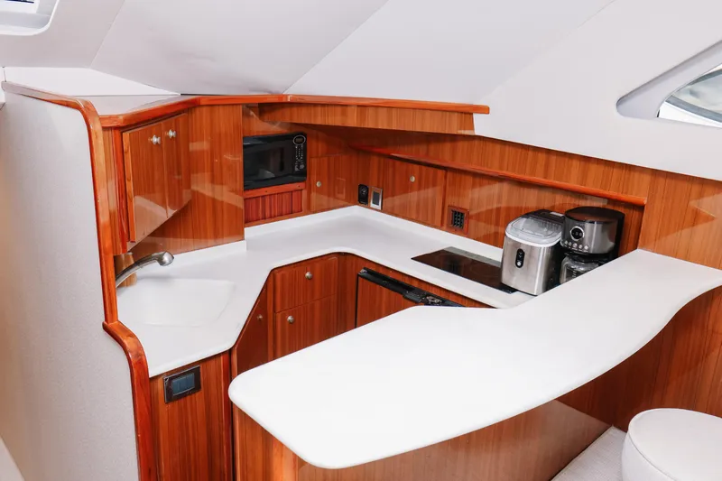 Slide: The Image of Luxurious galley in 2013 Viking 42 Convertible yacht with modern appliances and sleek wood cabinetry. - 41