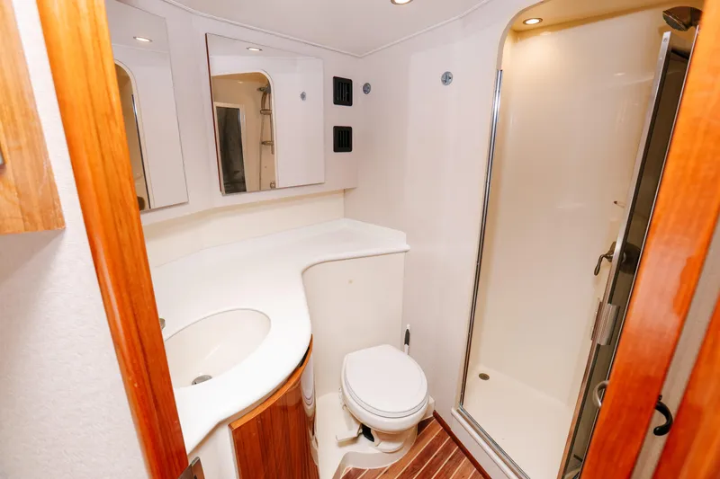 Slide: The Image of Bathroom interior of 2013 Viking 42 Convertible yacht with shower and wooden accents. - 43
