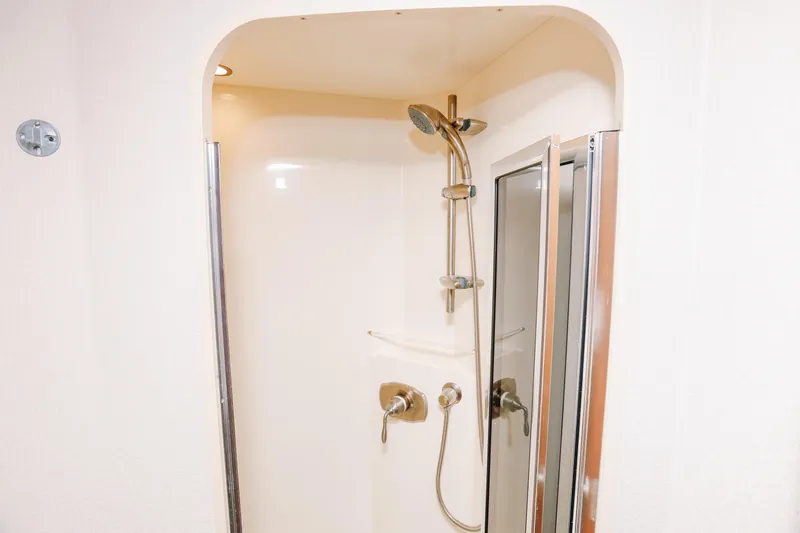 Slide: The Image of Shower area in 2013 Viking 42 Convertible yacht, featuring modern fixtures and glass door. - 44
