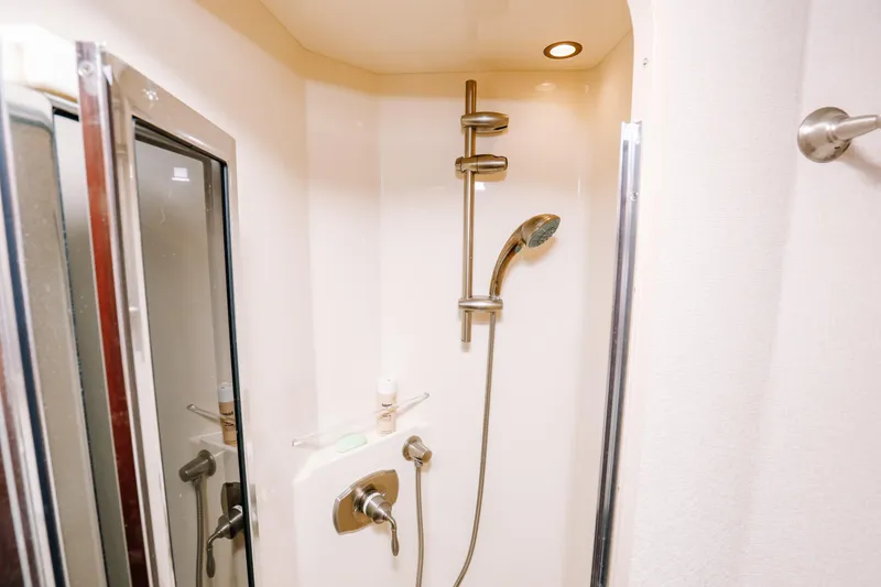 Slide: The Image of Shower area in 2013 Viking 42 Convertible yacht, featuring modern fixtures and lighting. - 45