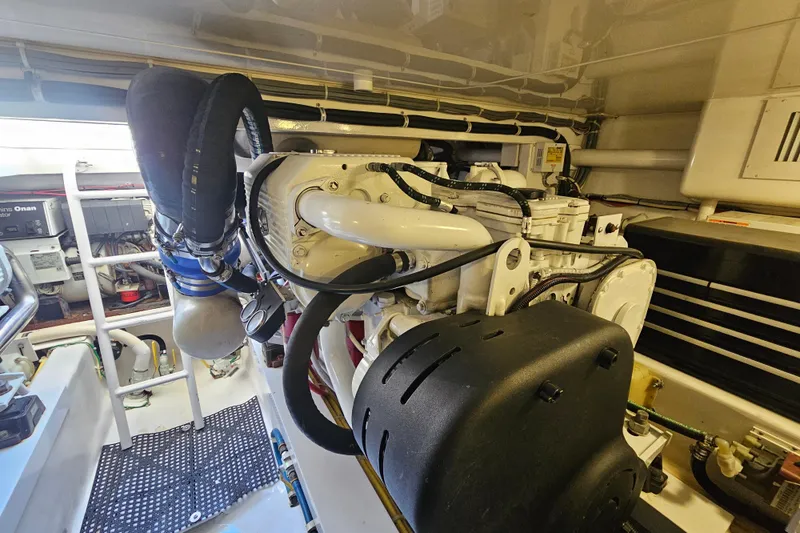 Slide: The Image of Engine room of 2013 Viking 42 Convertible yacht, showcasing detailed machinery and components. - 50