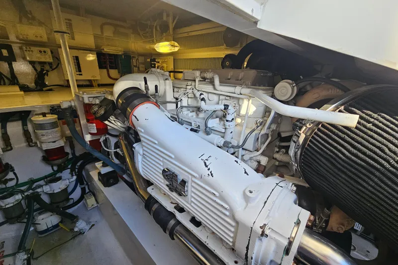 Slide: The Image of Engine room of 2013 Viking 42 Convertible yacht, showcasing detailed machinery and components. - 51