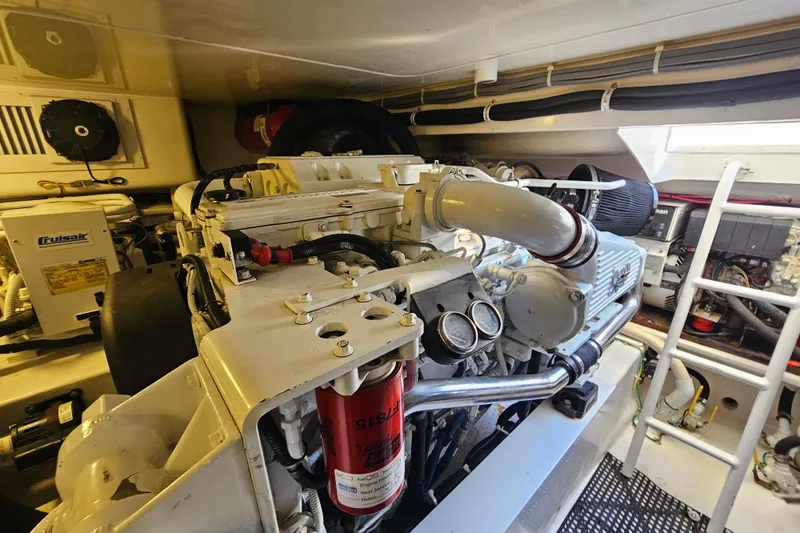 Slide: The Image of Engine room of 2013 Viking 42 Convertible yacht, showcasing detailed machinery and components. - 52