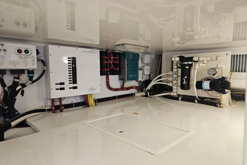 Slide: The Image of Engine room of 2013 Viking 42 Convertible yacht with electrical panels and plumbing. - 53