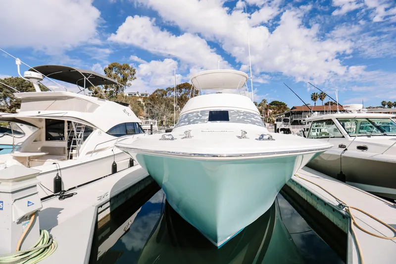 Slide: The Image of 2013 Viking 42 Convertible yacht docked under a vibrant blue sky. - 55