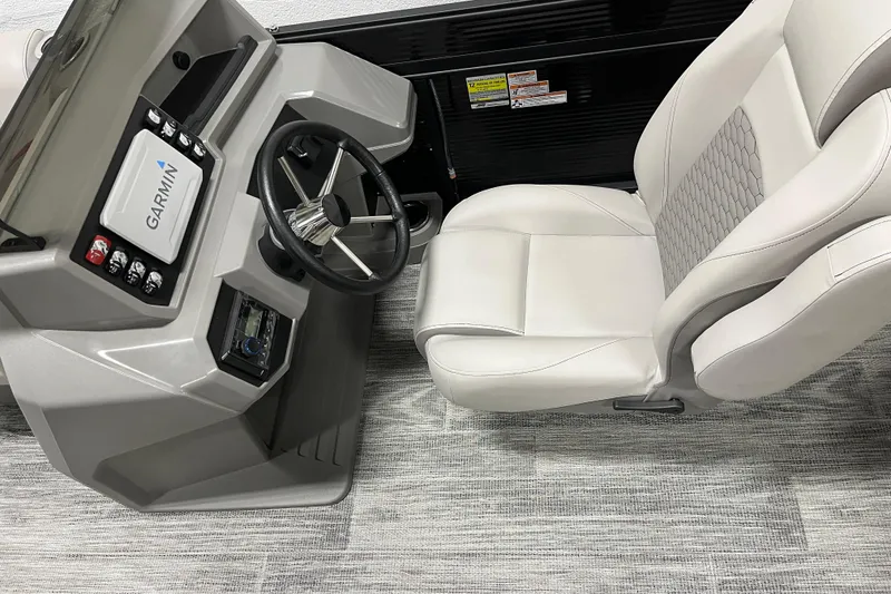 Slide: The Image of 2024 Qwest 8520 Lanai (XG02) boat interior with Garmin navigation and plush seating. - 7