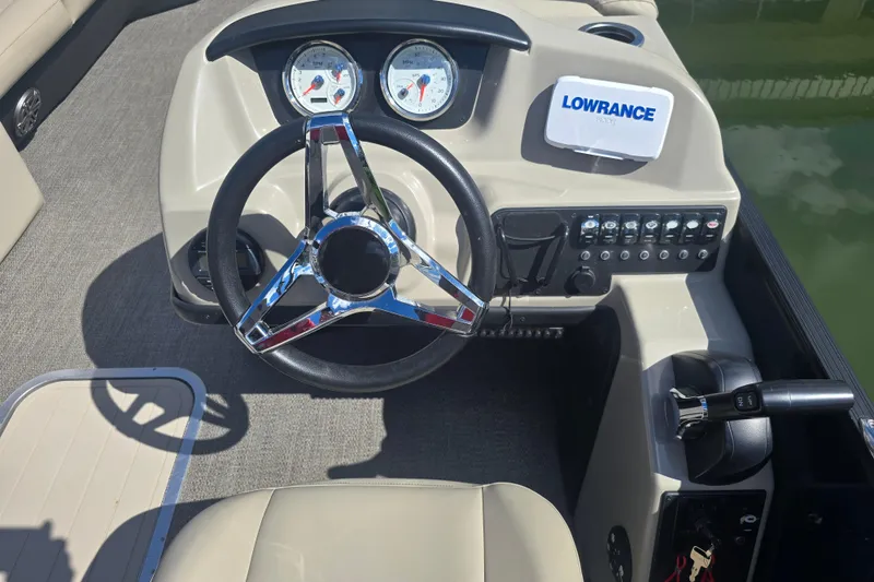 Slide: The Image of 2020 Barletta C24QC boat dashboard with steering wheel and control panel. - 11