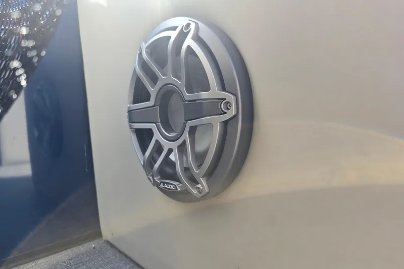 Slide: The Image of JL Audio speaker on 2020 Barletta C24QC boat, mounted on a sleek surface. - 13