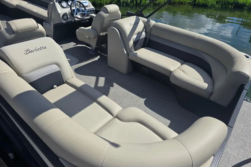 Slide: The Image of 2020 Barletta C24QC pontoon boat interior with luxurious seating and modern dashboard. - 15