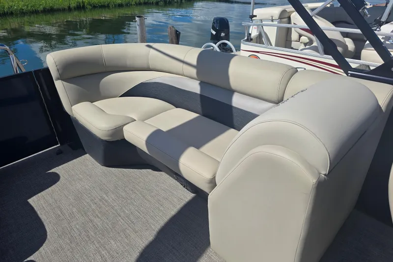 Slide: The Image of Luxurious seating on a 2020 Barletta C24QC pontoon boat, with water in the background. - 17