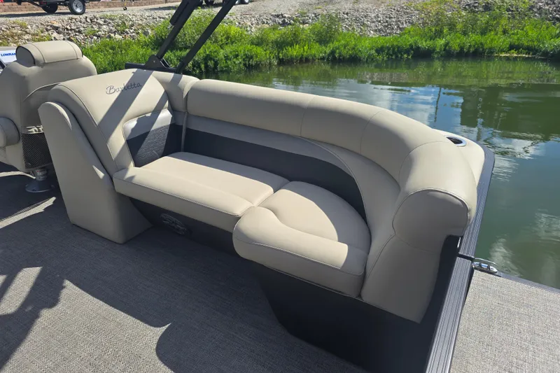 Slide: The Image of Luxurious seating on 2020 Barletta C24QC pontoon boat by the water. - 19