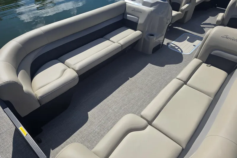 Slide: The Image of 2020 Barletta C24QC pontoon boat interior with beige seating and carpeted floor. - 5