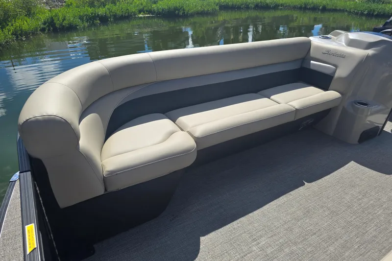 Slide: The Image of Luxurious seating on a 2020 Barletta C24QC pontoon boat, with plush beige upholstery. - 7