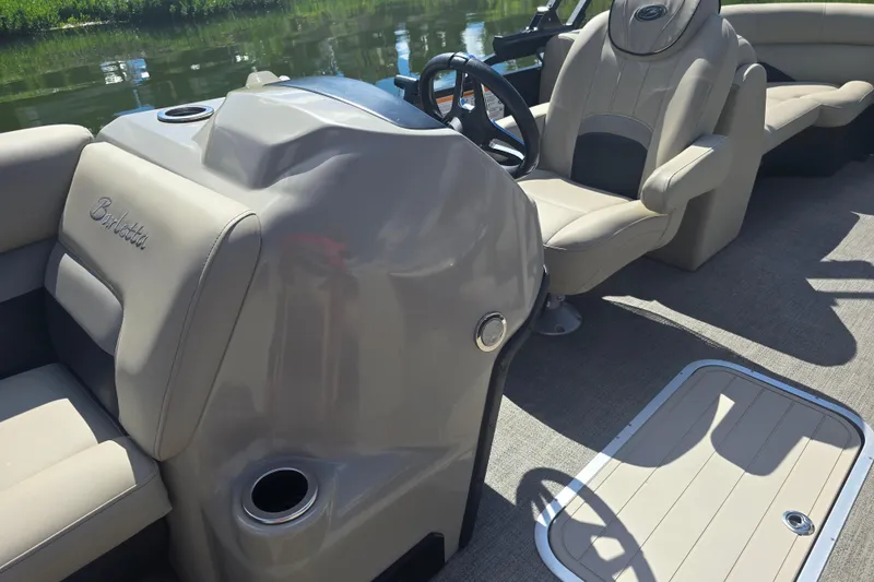 Slide: The Image of 2020 Barletta C24QC boat interior with beige seating and steering console. - 9