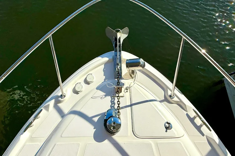 Slide: The Image of Bow of 2006 Sea Ray 320 Sundancer with anchor and railing on calm water. - 18