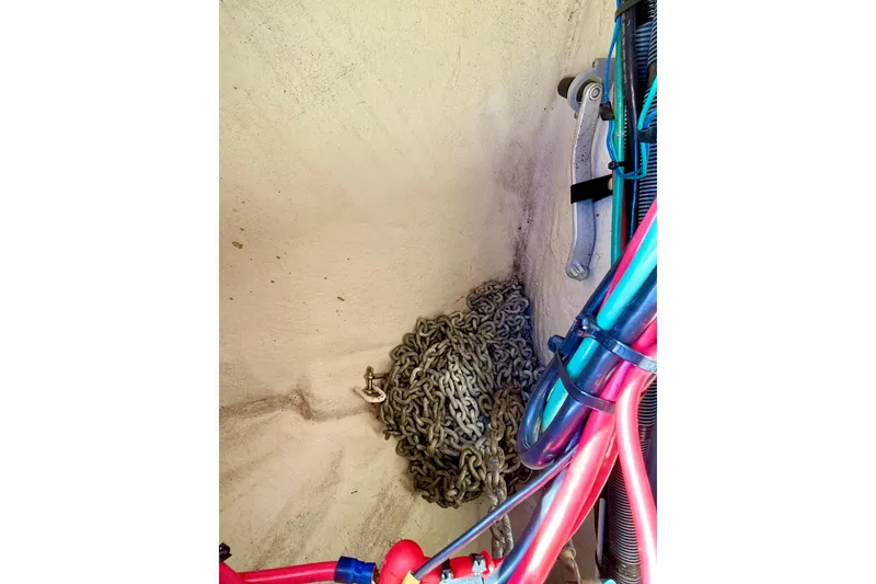 Slide: The Image of Anchor chain and cables in a 2006 Sea Ray 320 Sundancer boat compartment. - 20