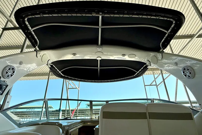 Slide: The Image of 2006 Sea Ray 320 Sundancer boat interior with canopy and speakers. - 23