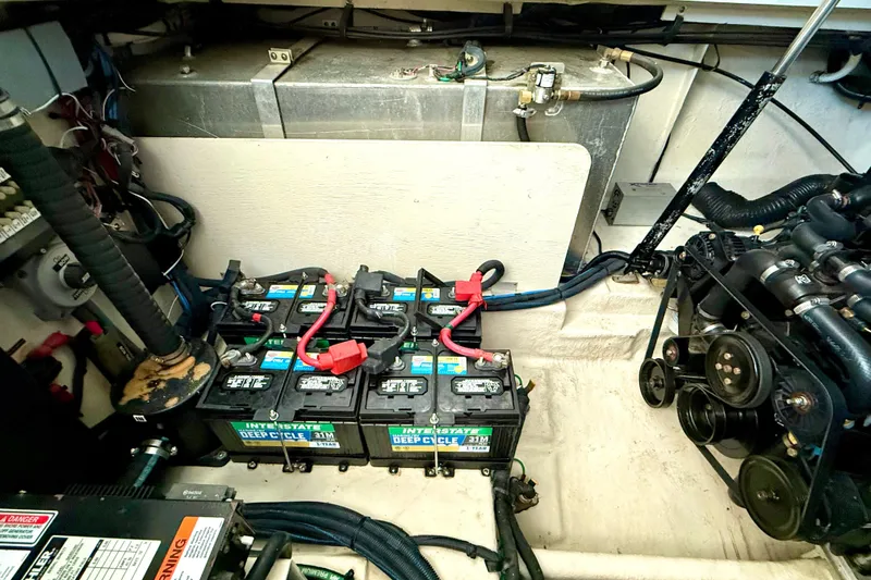 Slide: The Image of Engine compartment of a 2006 Sea Ray 320 Sundancer with batteries and mechanical components. - 27
