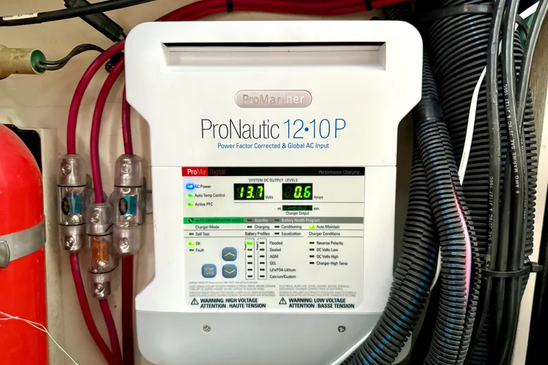 Slide: The Image of ProNautic 12:10P charger on 2006 Sea Ray 320 Sundancer, displaying voltage and amperage. - 31