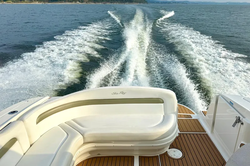 Slide: The Image of 2006 Sea Ray 320 Sundancer cruising, leaving a wake on open water. - 34