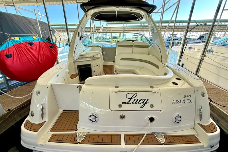 Slide: The Image of 2006 Sea Ray 320 Sundancer boat docked, featuring spacious seating and elegant design. - 37