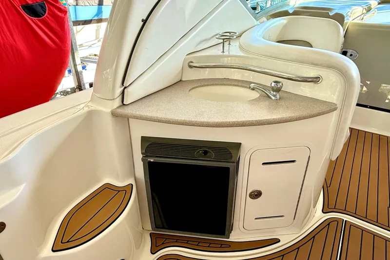 Slide: The Image of 2006 Sea Ray 320 Sundancer boat interior with sink, countertop, and mini fridge. - 41