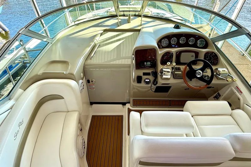 Slide: The Image of 2006 Sea Ray 320 Sundancer cockpit with luxurious seating and modern controls. - 42