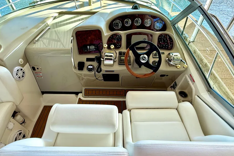 Slide: The Image of Helm of 2006 Sea Ray 320 Sundancer with leather seating and modern controls. - 43