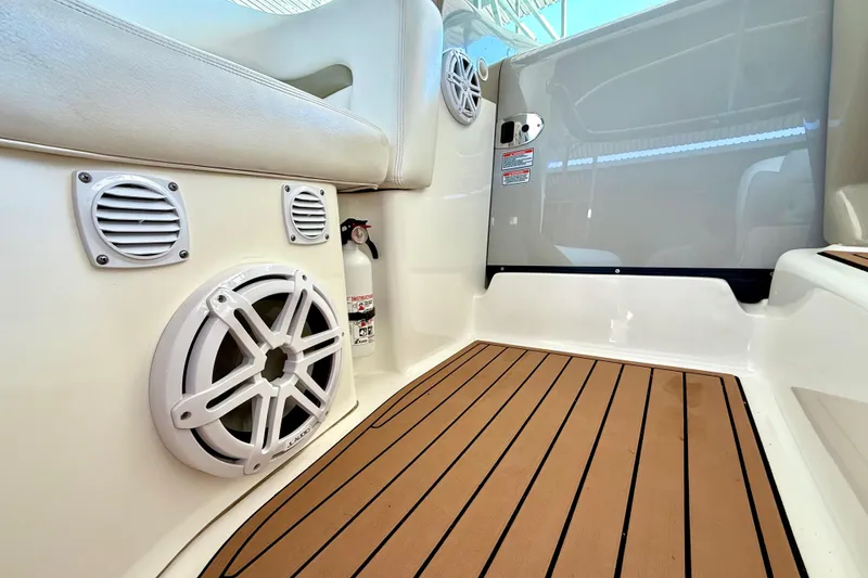 Slide: The Image of 2006 Sea Ray 320 Sundancer interior with speakers, fire extinguisher, and teak flooring. - 45