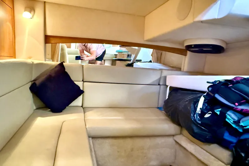 Slide: The Image of Interior of 2006 Sea Ray 320 Sundancer with beige seating and a black pillow. - 52