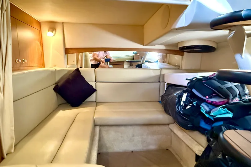 Slide: The Image of Interior of 2006 Sea Ray 320 Sundancer with beige seating and storage. - 55