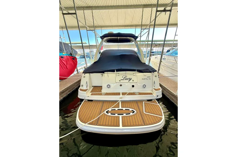 Slide: The Image of 2006 Sea Ray 320 Sundancer docked, rear view with covered deck, named "Lucy" in Austin, TX. - 9