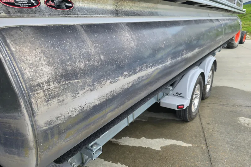 Slide: The Image of 2017 Harris Solstice 240 pontoon boat on EZ Loader trailer, showing weathered exterior. - 11