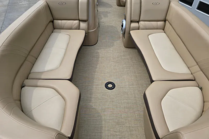 Slide: The Image of 2017 Harris Solstice 240 boat interior with beige seating and carpeted floor. - 14