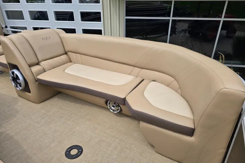Slide: The Image of 2017 Harris Solstice 240 boat interior with beige seating and integrated speaker system. - 16