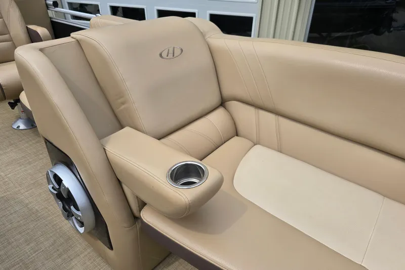 Slide: The Image of 2017 Harris Solstice 240 boat interior with beige leather seating and cup holder. - 17