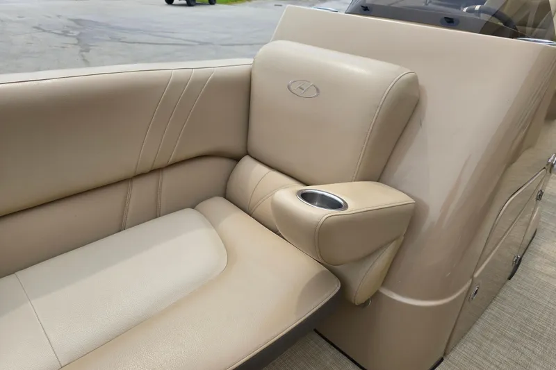 Slide: The Image of Luxurious beige seating on 2017 Harris Solstice 240 boat with integrated cup holder. - 18